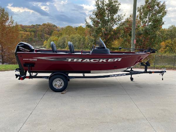 Tracker Pro Guide V-16 SC 2025 Tracker Pro Guide V-16 SC boat on trailer, red exterior, parked outdoors.