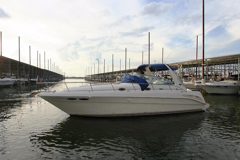 Sea Ray 340 Sundancer 2001 Sea Ray 340 Sundancer yacht docked in a marina under a cloudy sky.