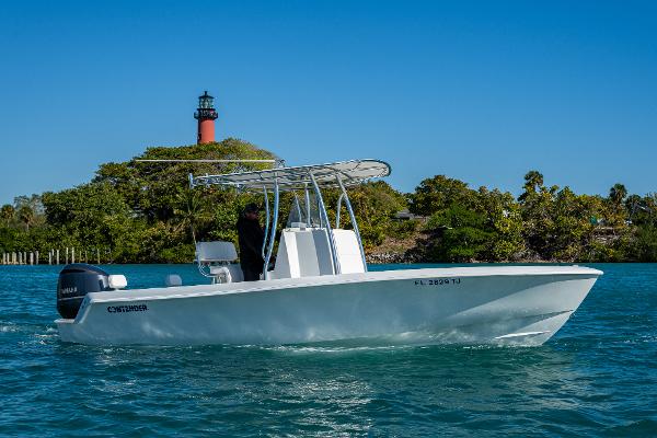 Contender 24 Sport 2023 Contender 24 Sport boat cruising near a lighthouse on a sunny day.