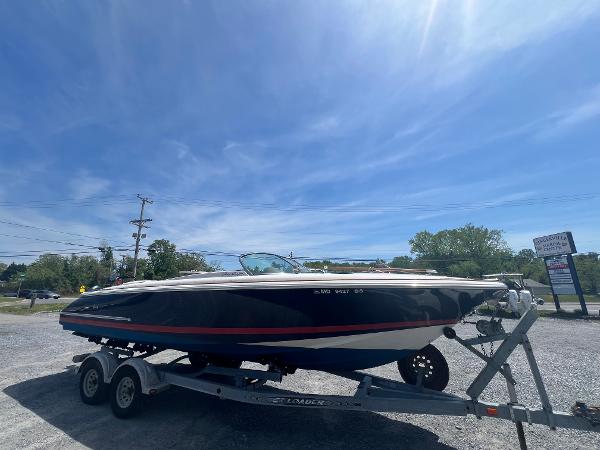 Chris-Craft Corsair 25 2004 Chris-Craft Corsair 25 boat on trailer under clear blue sky.
