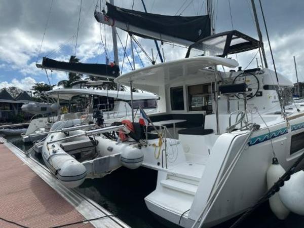Lagoon 40 2019 Lagoon 40 catamaran docked at marina, featuring spacious deck and modern design.
