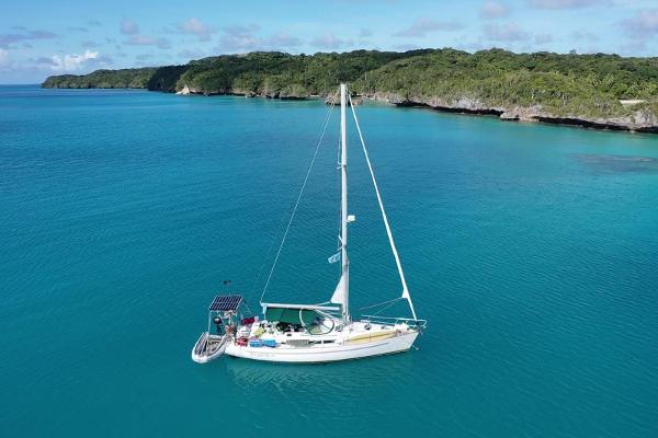 Beneteau Oceanis 40 CC Sailboat Beneteau Oceanis 40 CC, 1995, anchored in turquoise waters near lush coastline.