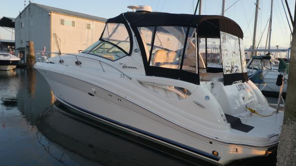 Sea Ray 340 Sundancer 2007 Sea Ray 340 Sundancer boat docked at marina, featuring sleek design and black canopy.