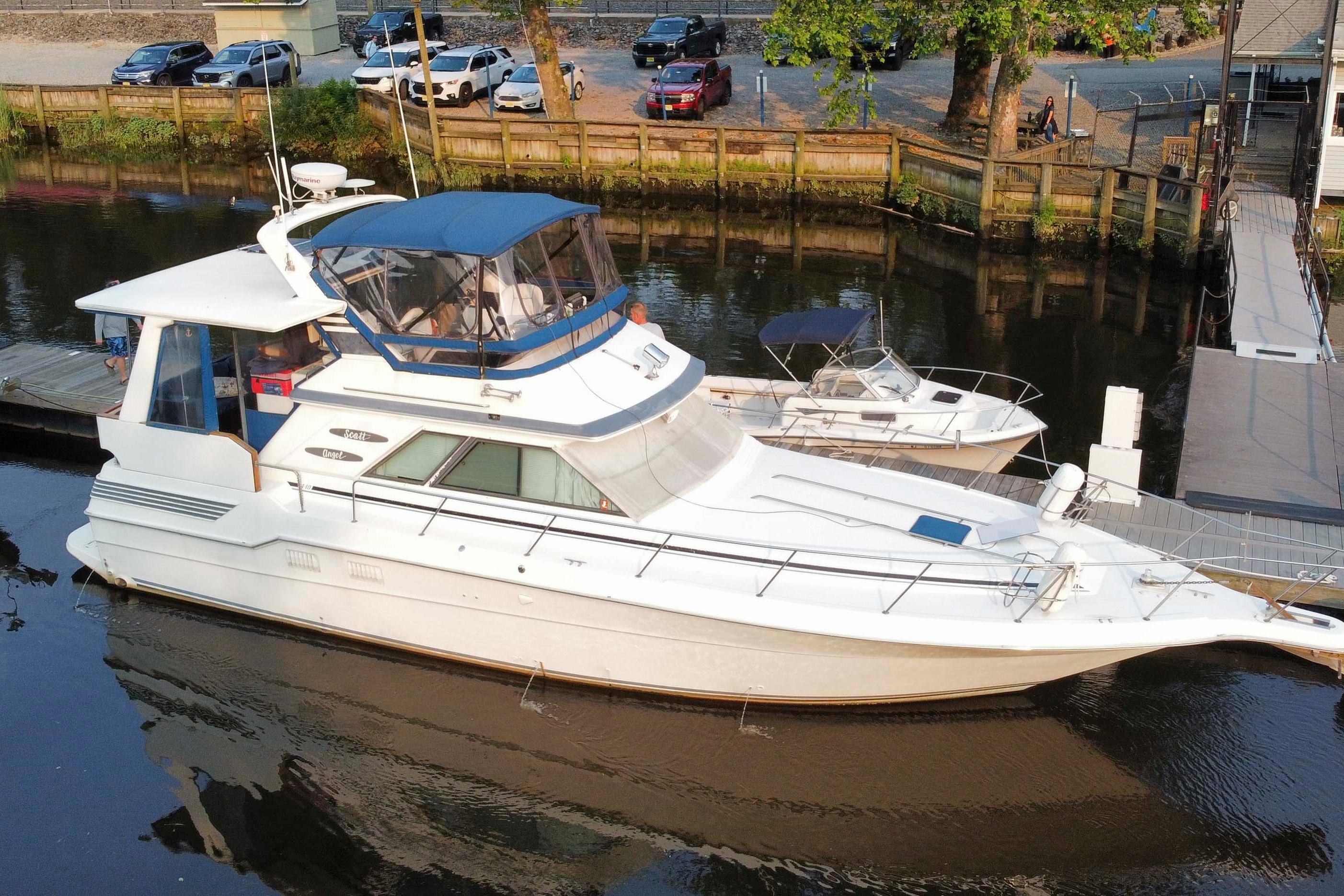 Sea Ray 440 Aft Cabin 1990 Sea Ray 440 Aft Cabin yacht docked in a serene marina setting.