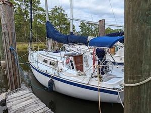 Hinterhoeller Niagra 31 1983 Hinterhoeller Niagara 31 sailboat docked, featuring blue sail covers and wooden accents.