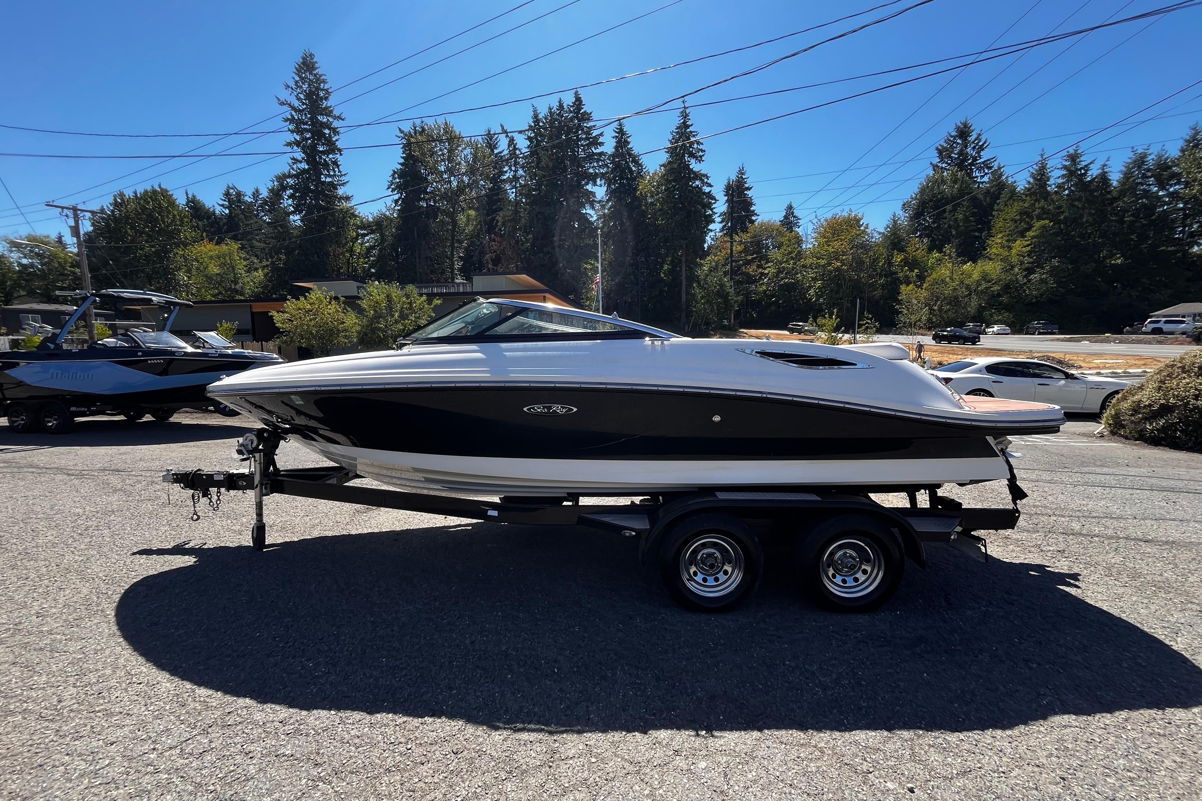 Sea Ray 210 SLX 2014 Sea Ray 210 SLX boat on trailer, parked outdoors under clear blue sky.