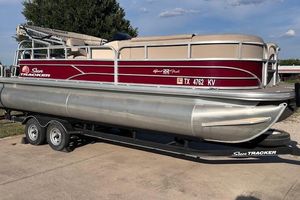 Sun Tracker SportFish 22 DLX 2018 Sun Tracker SportFish 22 DLX pontoon boat on trailer, parked outdoors.