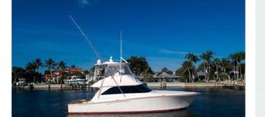 Viking 45 Convertible 2004 Viking 45 Convertible yacht on calm water with palm trees in the background.