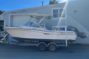 Grady-White Freedom 255 2013 Grady-White Freedom 255 boat on trailer, parked near a building.