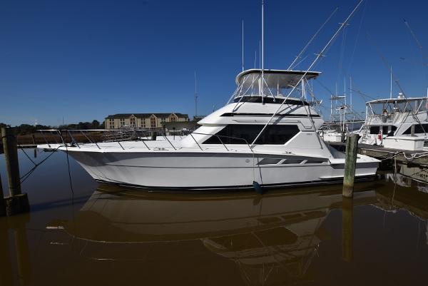 Hatteras 50 Convertible 1996 Hatteras 50 Convertible yacht docked in marina, side view.