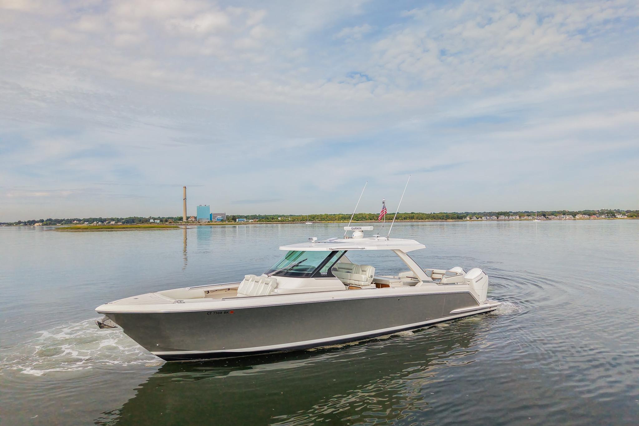 Tiara Yachts 43 LS 2025 Tiara Yachts 43 LS cruising on calm waters under a cloudy sky.