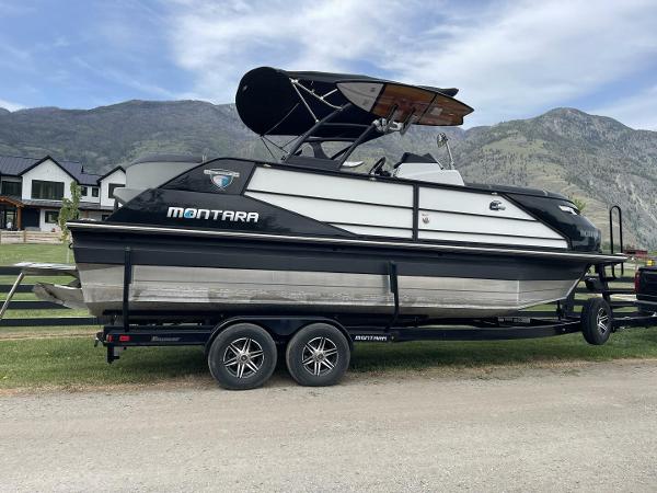 Montara SurfBoss 2.0 23 2021 Montara SurfBoss 2.0 23 boat on trailer, scenic mountain backdrop.