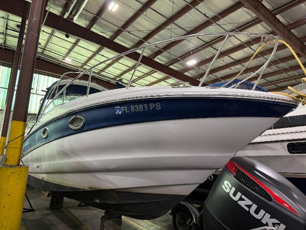 Crownline 250 CR 2007 Crownline 250 CR boat in storage, featuring a blue and white hull.