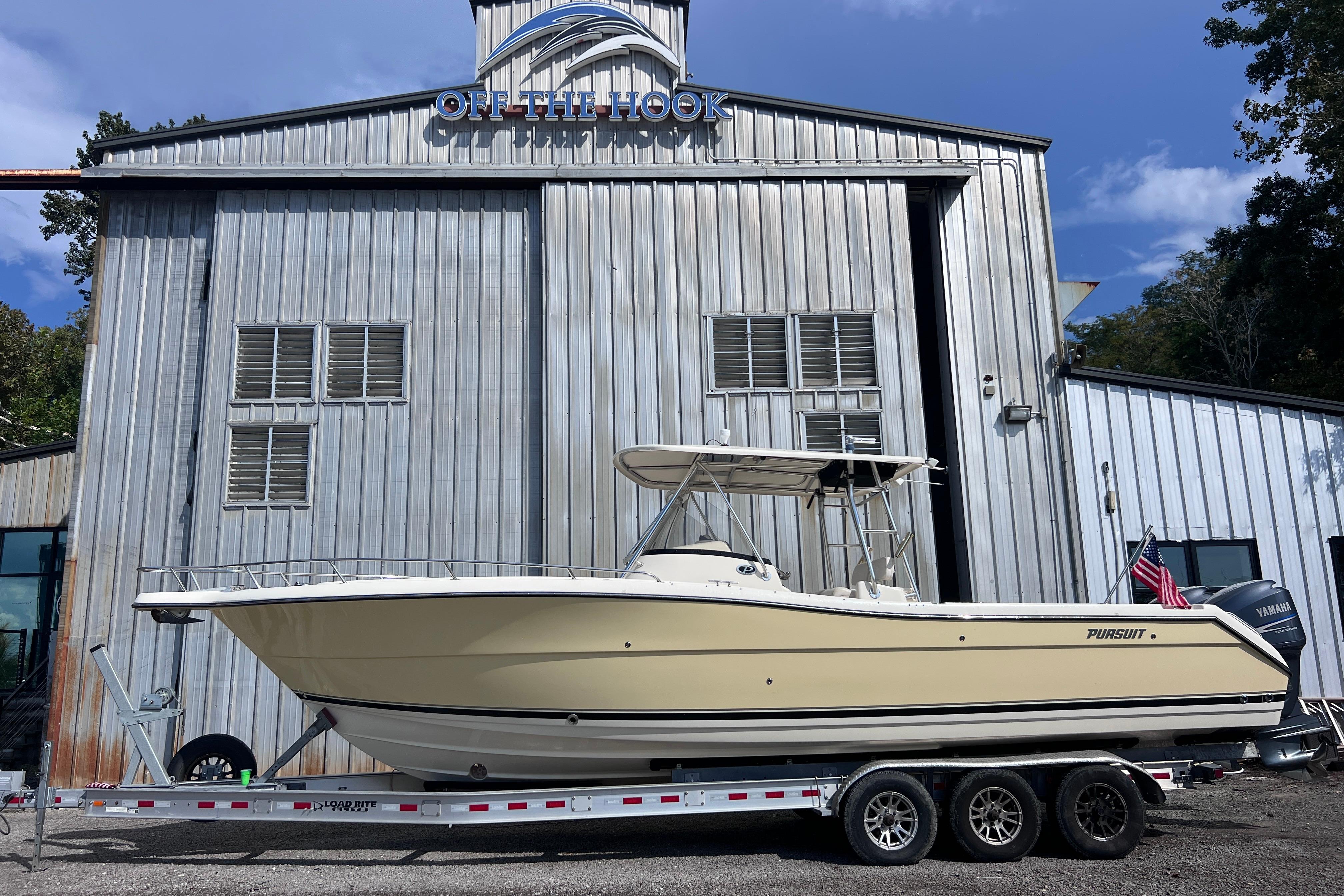 Pursuit C 300 Center Console 2007 Pursuit C 300 Center Console boat on trailer outside metal building.