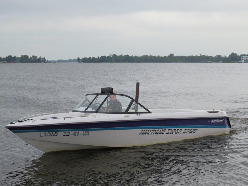 Correct Craft Ski Nautique 1995 Correct Craft Ski Nautique boat on a calm lake.