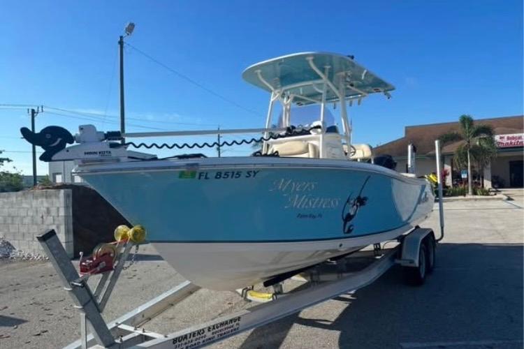NauticStar 2302 Legacy 2021 NauticStar 2302 Legacy boat on trailer, blue hull, parked outdoors under clear sky.