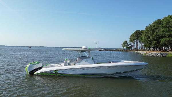 Statement 350 Open 2023 Statement 350 Open boat on calm water near a tree-lined shore.