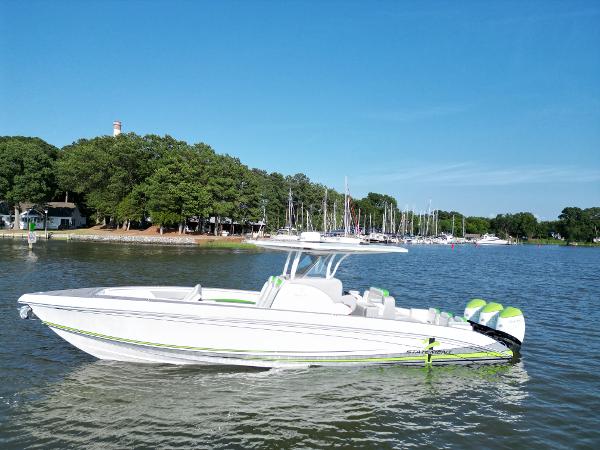 Statement 350 Open 2023 Statement 350 Open boat on calm water near a marina with trees in the background.