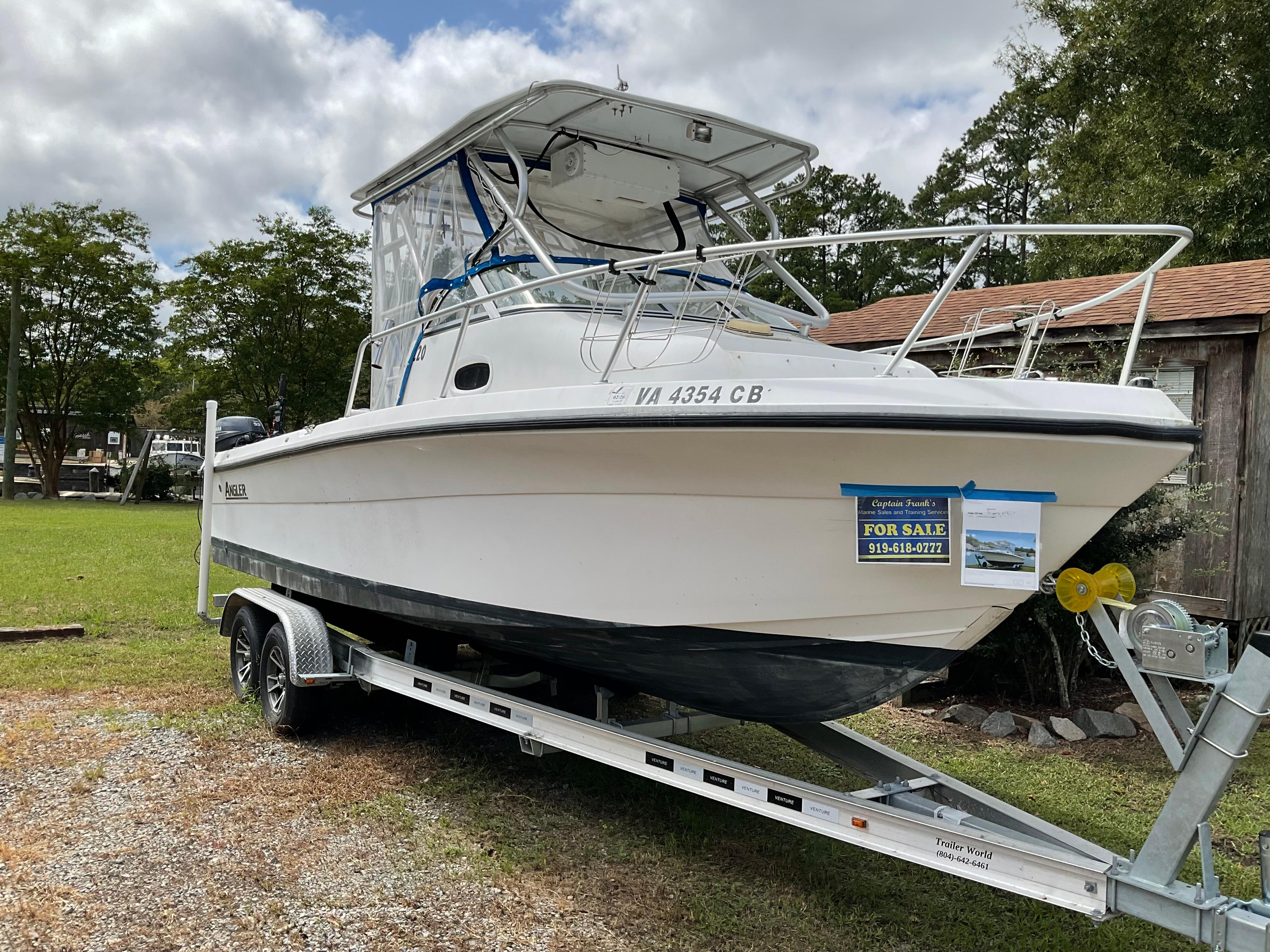 Angler 220WA 2004 Angler 220WA boat on trailer, for sale sign visible, parked on grass.