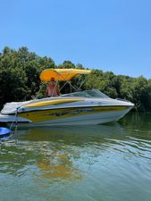 Crownline 210 LS 2006 Crownline 210 LS boat with yellow canopy on a calm lake.