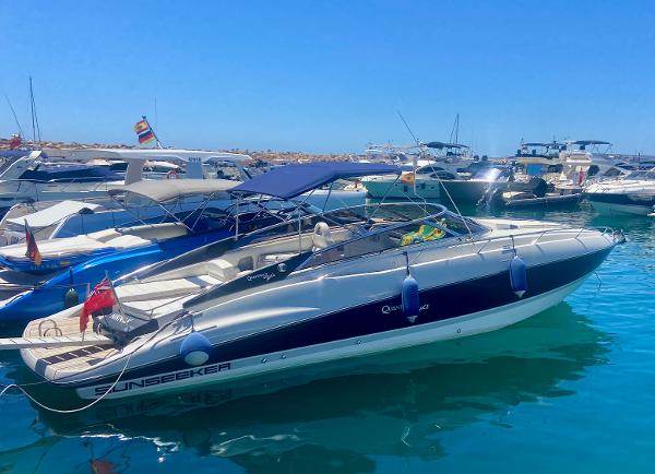 Sunseeker Superhawk 43 2009 Sunseeker Superhawk 43 yacht docked in a marina under clear blue skies.