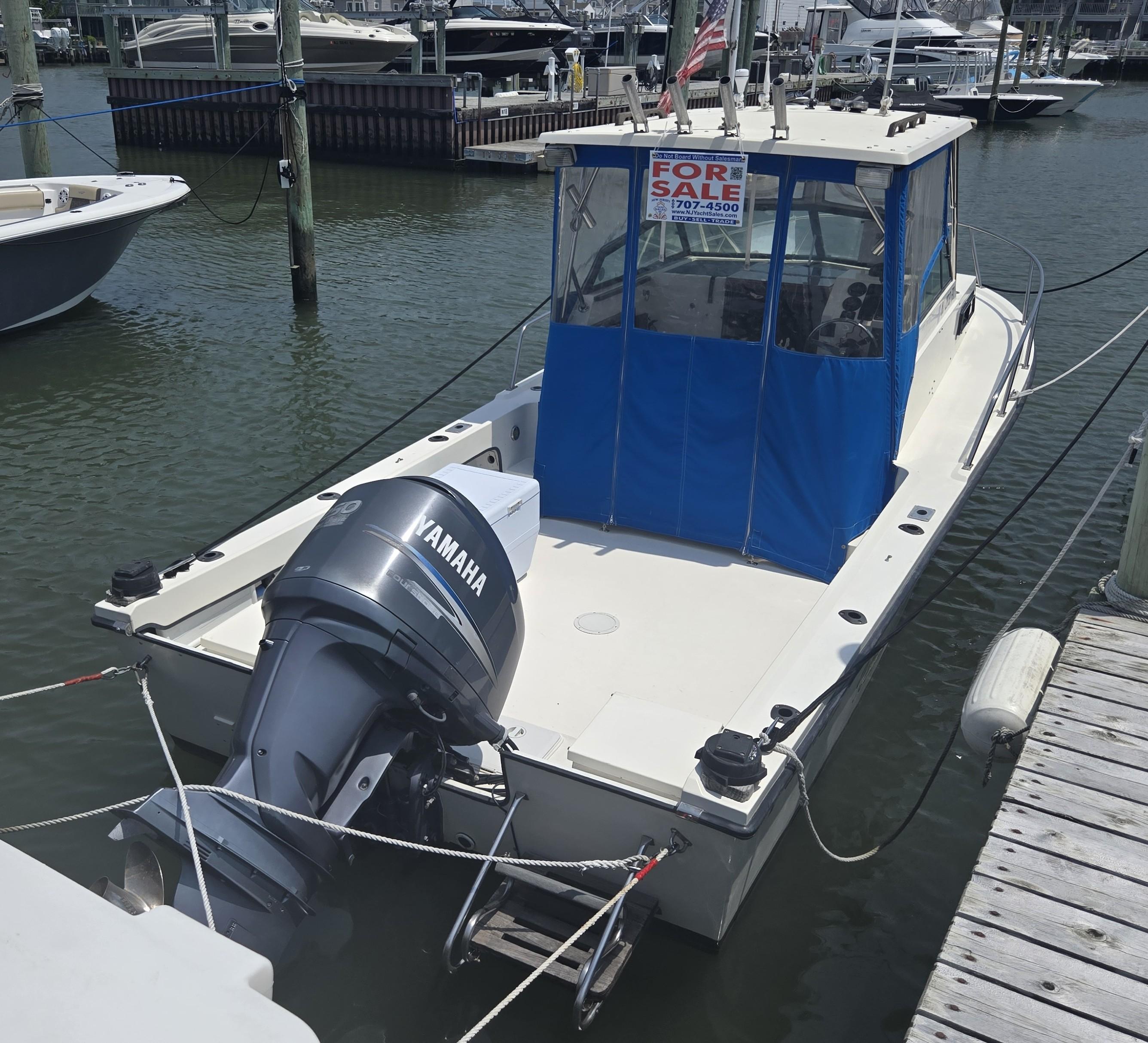 Parker 2310 Walkaround 1989 Parker 2310 Walkaround boat with Yamaha motor, docked and for sale.