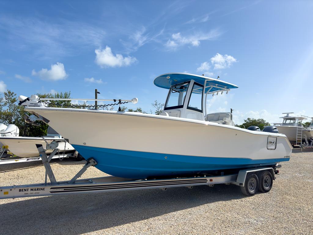 Sea Hunt Gamefish 27 Forward Seating 2023 Sea Hunt Gamefish 27 boat on trailer under clear blue sky.