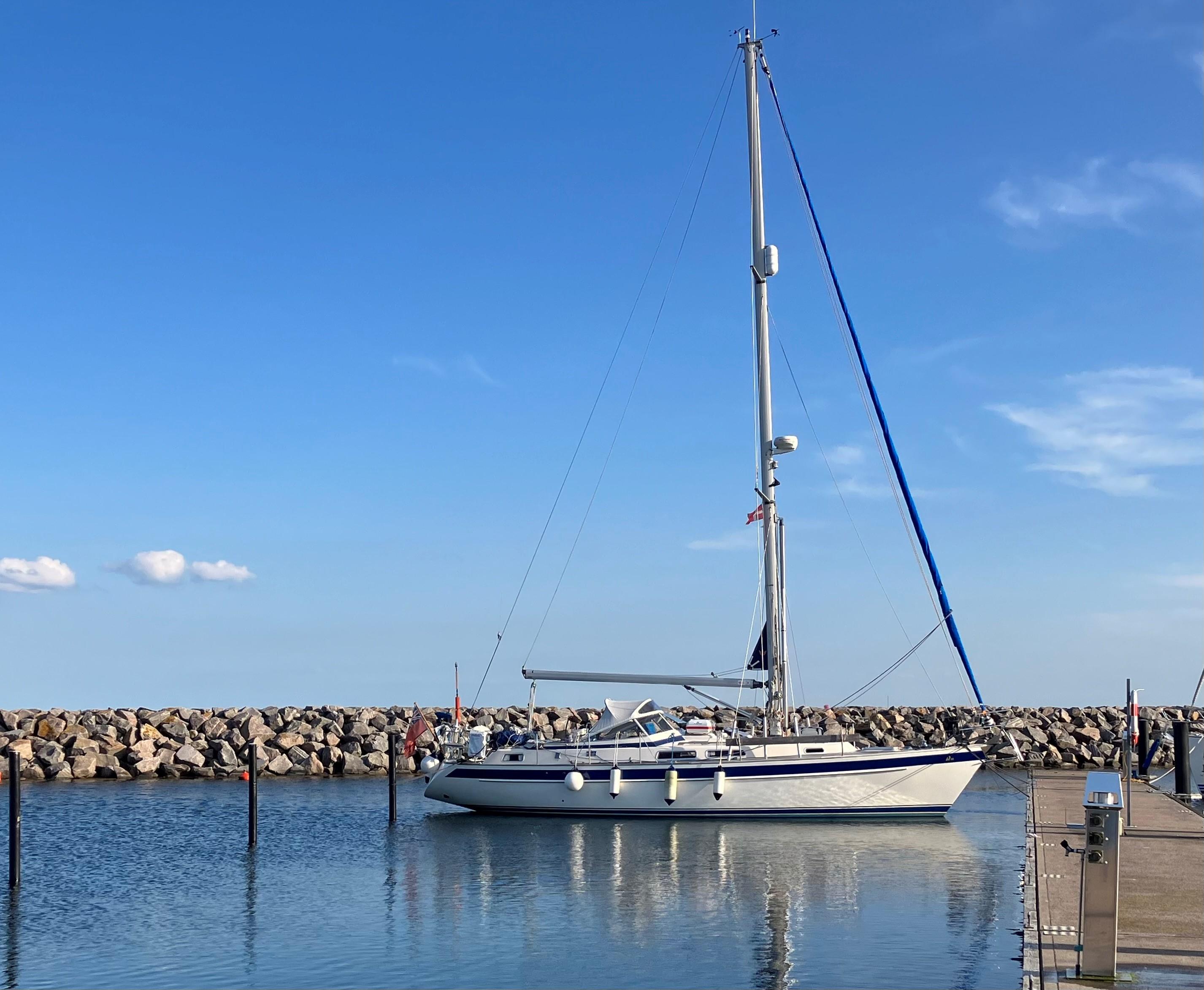 Hallberg-Rassy 36 Sailboat Hallberg-Rassy 36, 1999 model, docked in a calm marina with clear blue skies.