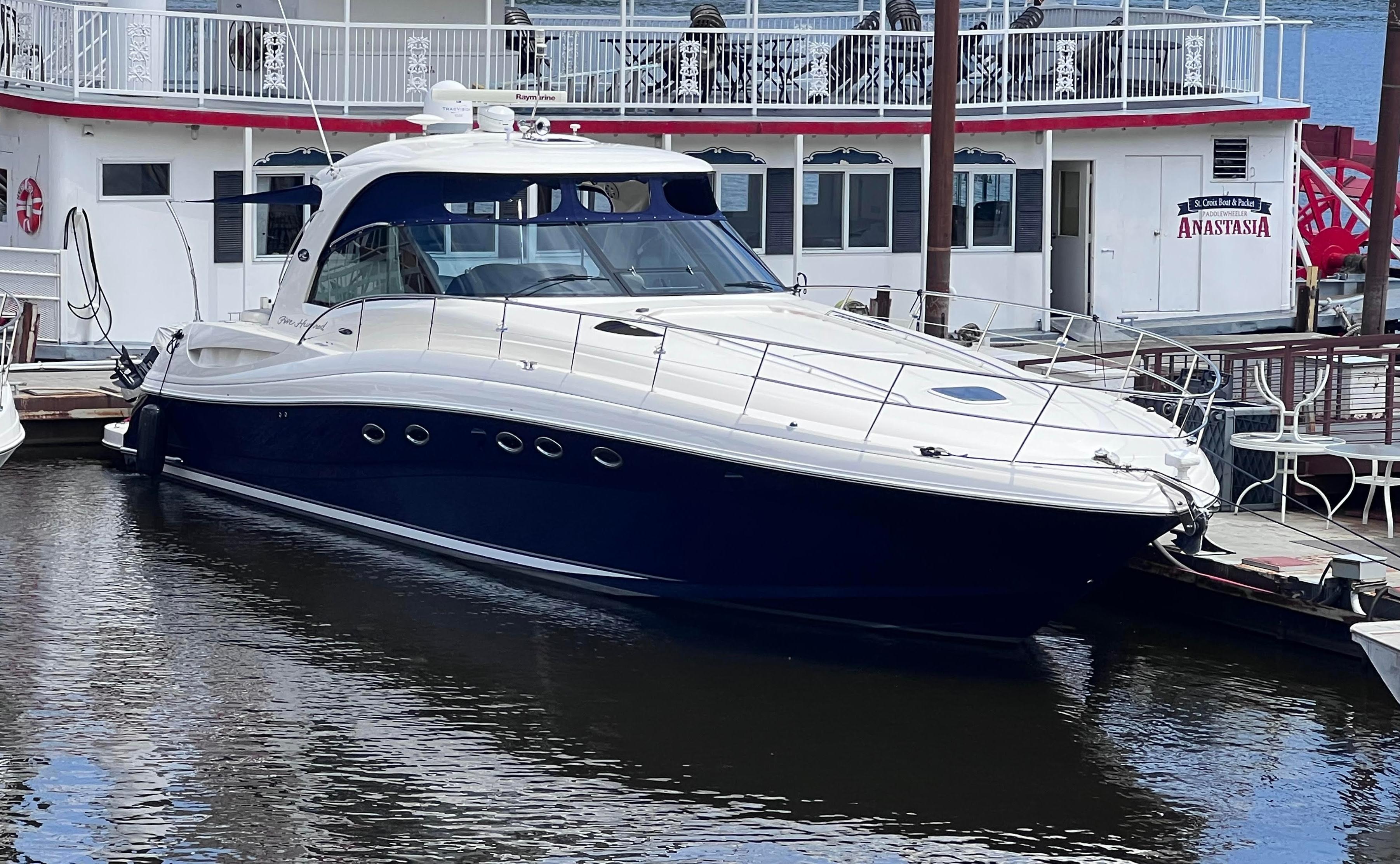 Sea Ray 500 Sundancer 2005 Sea Ray 500 Sundancer yacht docked beside a riverboat.