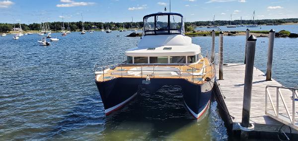 Lagoon 43 PC 2004 Lagoon 43 PC catamaran docked in a scenic marina.