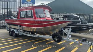 Spartan 240 MAXIUS PRO 2024 Spartan 240 MAXIUS PRO boat on trailer, red and silver design, parked outdoors.