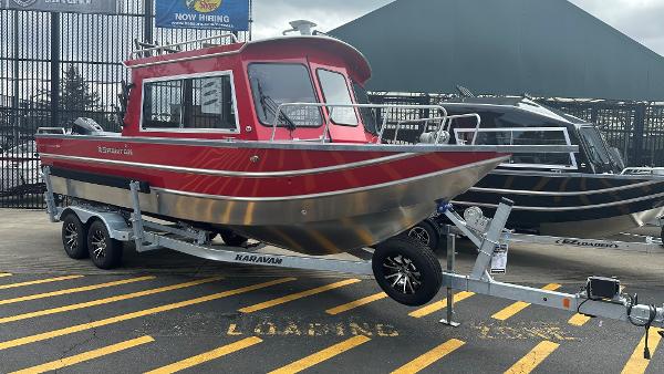 Spartan 240 MAXIUS PRO 2024 Spartan 240 MAXIUS PRO boat on trailer, red and silver design, parked outdoors.