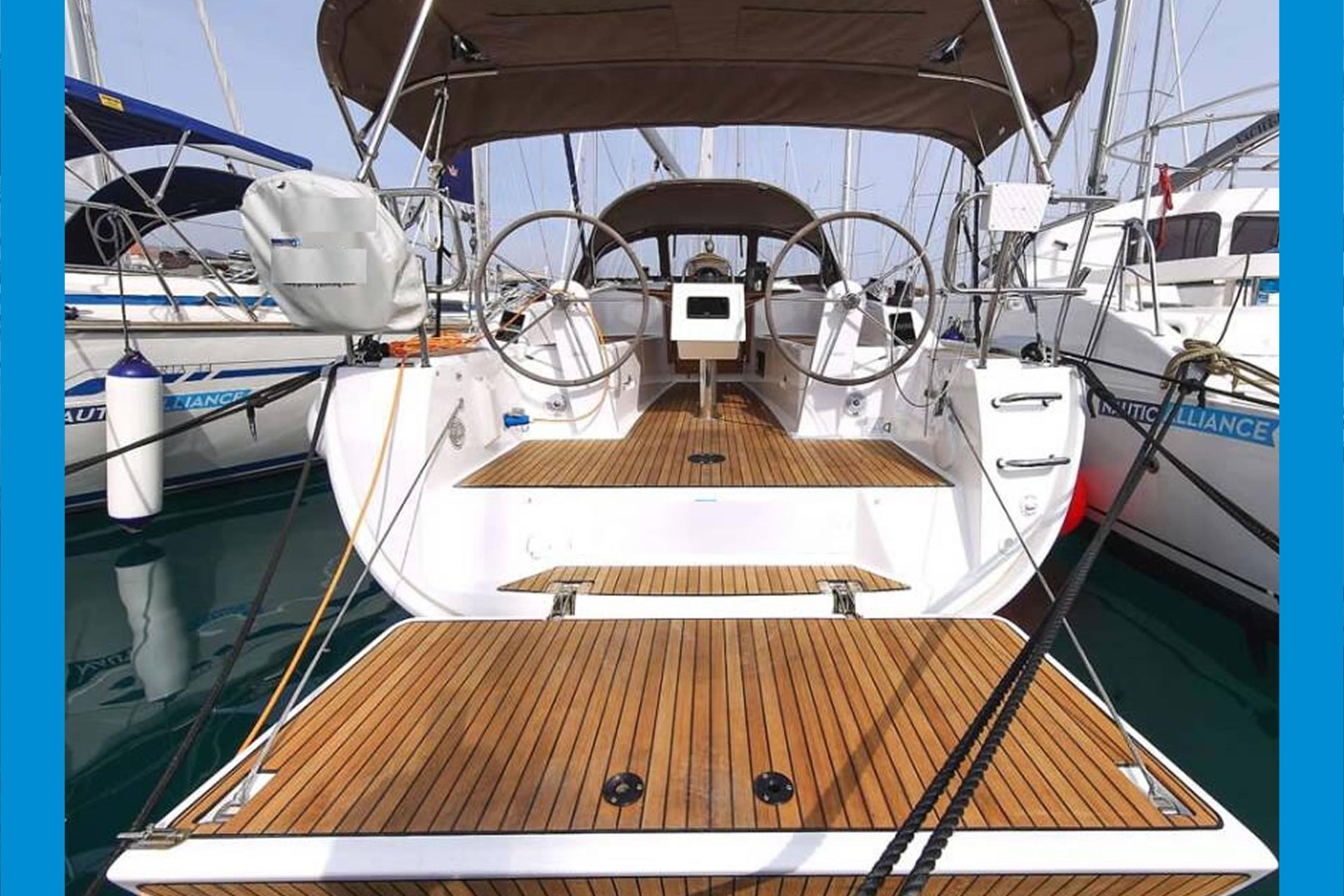 Bavaria 34 Cruiser Bavaria 34 Cruiser 2017 yacht with wooden deck and dual steering wheels in marina.