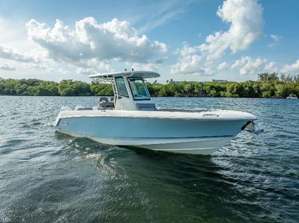 Boston Whaler 280 Outrage 2023 Boston Whaler 280 Outrage boat on calm water under a partly cloudy sky.
