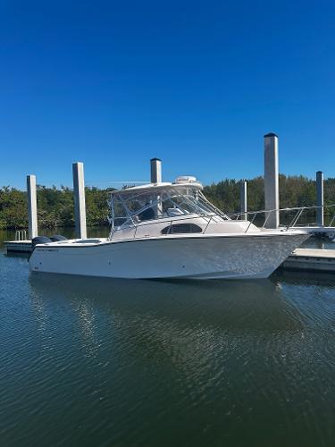 Grady-White Marlin 300 2008 Grady-White Marlin 300 boat docked in calm waters under clear blue sky.