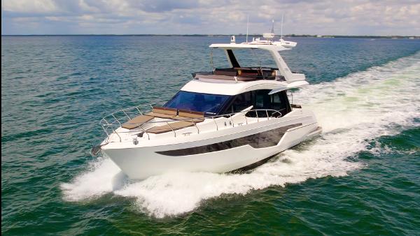 Galeon 500 Fly 2021 Galeon 500 Fly yacht cruising on open water under a partly cloudy sky.