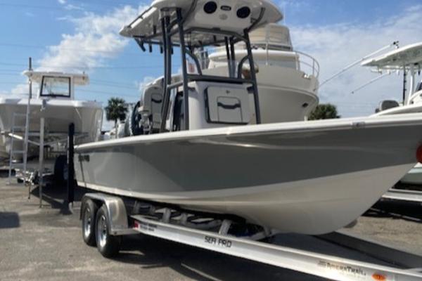 Sea Pro 230 Bay 2025 Sea Pro 230 Bay boat on trailer, parked in marina under clear sky.
