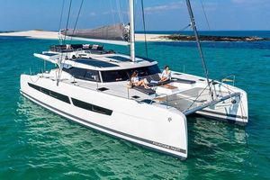 Fountaine Pajot Catamaran Aura 51 2024 Fountaine Pajot Catamaran Aura 51 sailing in clear turquoise waters.