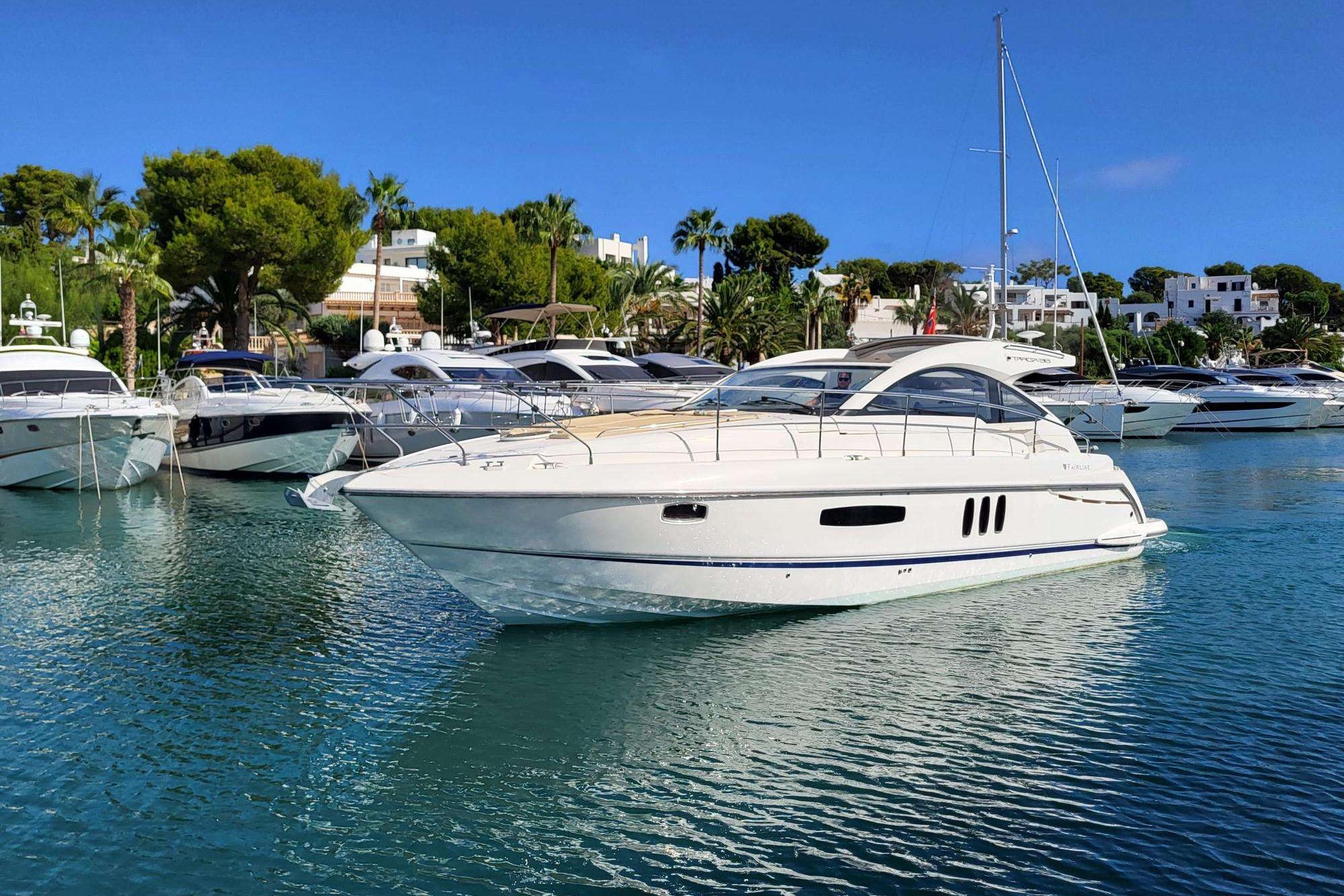 Fairline Targa 38 2012 Fairline Targa 38 yacht docked in a scenic marina with clear blue water.