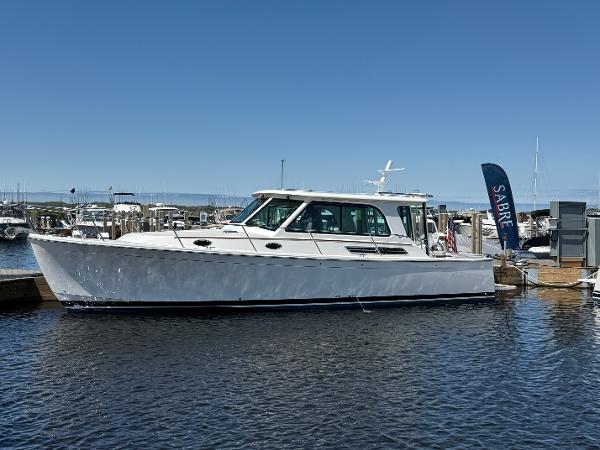 Back Cove 372 2025 Back Cove 372 boat docked at marina under clear blue sky.