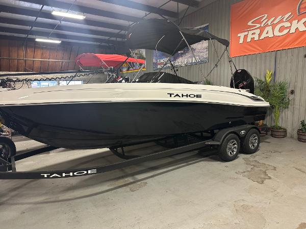 Tahoe T21 2025 Tahoe T21 boat on trailer in showroom with Sun Tracker sign.