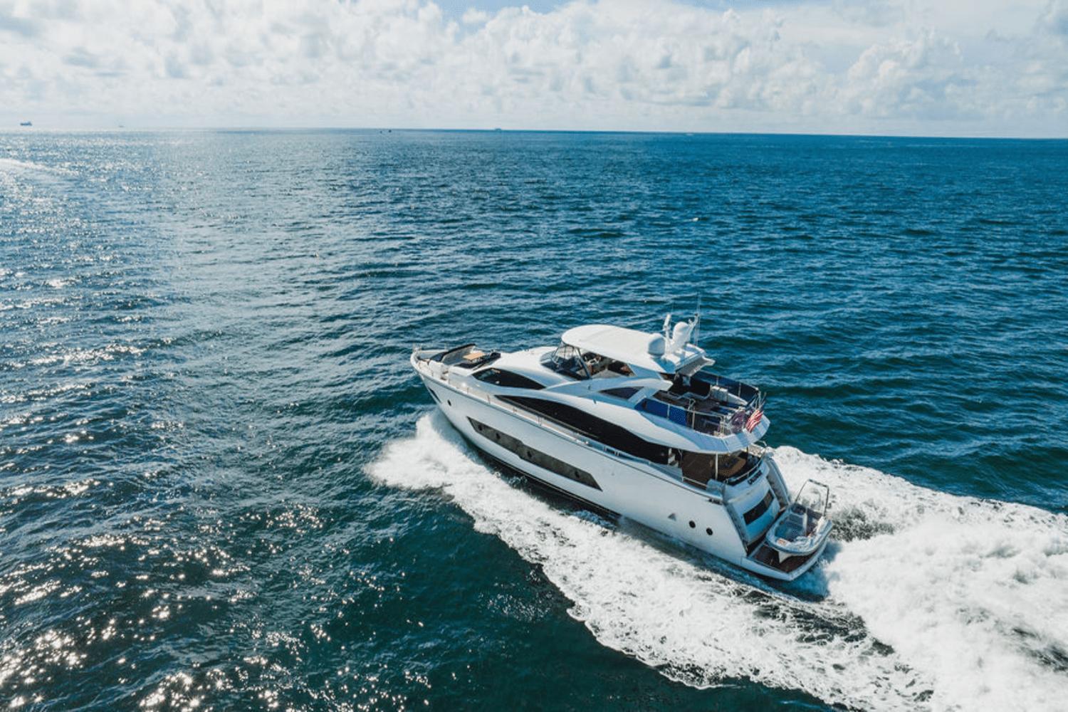 Sunseeker 86 Yacht 2019 Sunseeker 86 Yacht cruising on open ocean under clear skies.