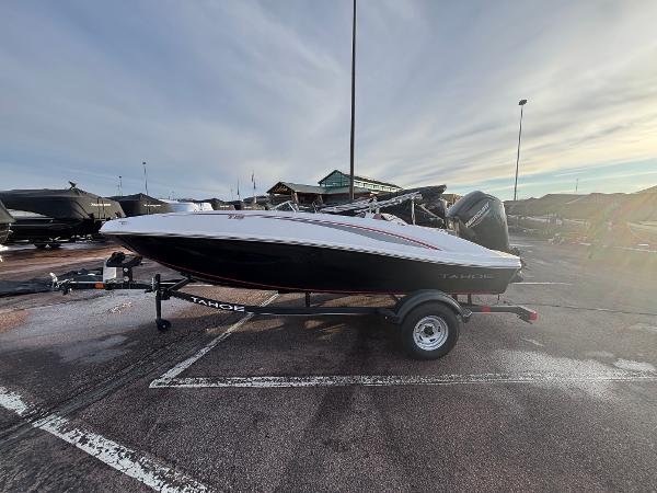 Tahoe T16 2023 Tahoe T16 boat on trailer in parking lot, overcast sky.