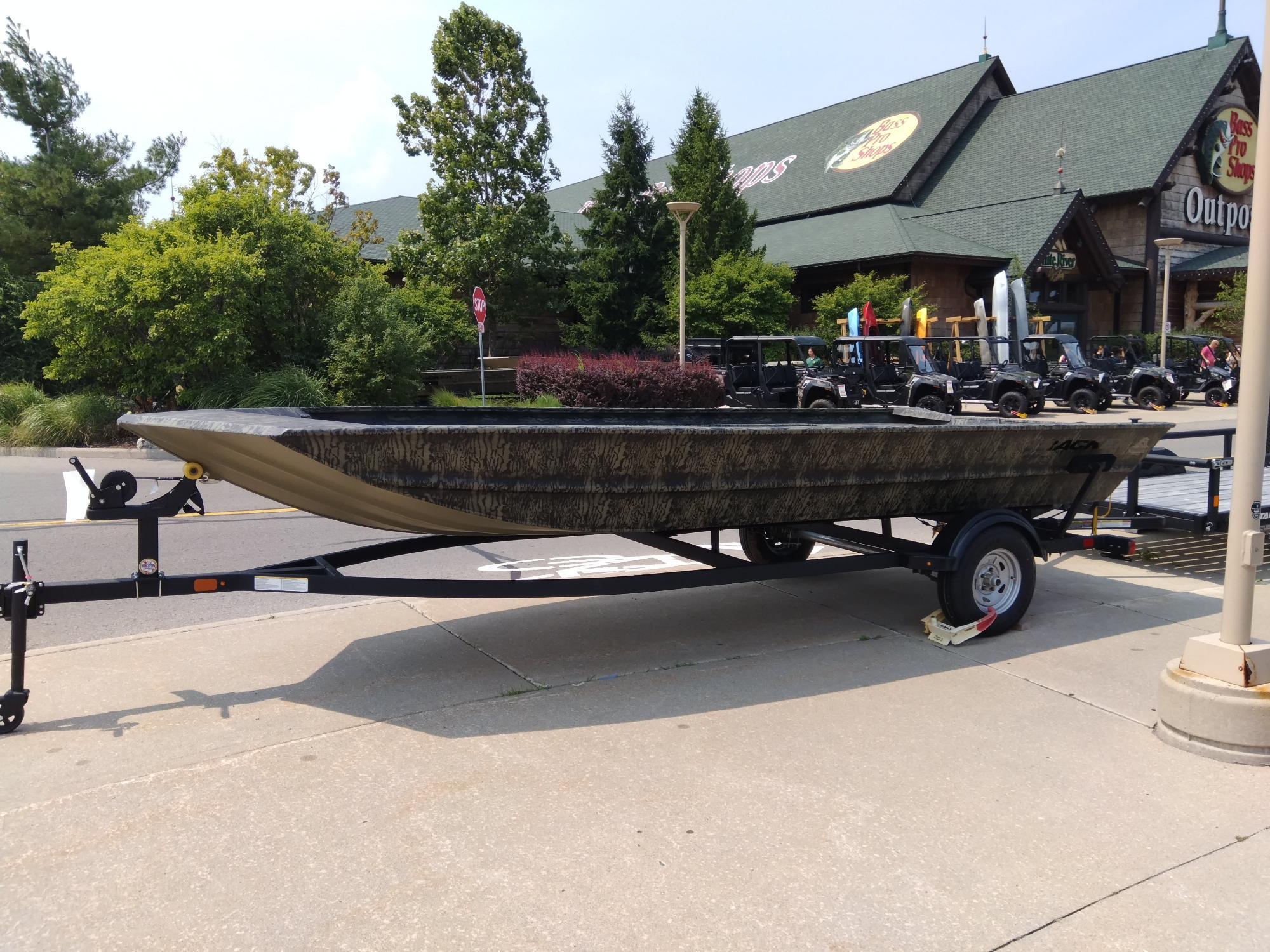 Tracker GRIZZLY 1860 Utility 2025 Tracker GRIZZLY 1860 Utility boat on trailer outside store.