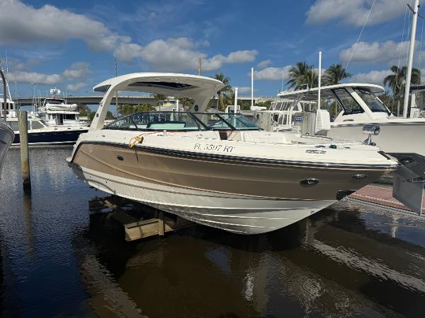 Sea Ray SLX 310 Outboard 2019 Sea Ray SLX 310 OB boat docked in marina under blue sky.