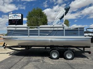 Landau Island Breeze 212 2023 Landau Island Breeze 212 pontoon boat on trailer under blue sky.