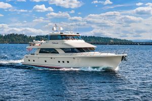 Ocean Alexander 80 Motoryacht Ocean Alexander 80 Motoryacht 2010 cruising on a sunny day with scenic backdrop.