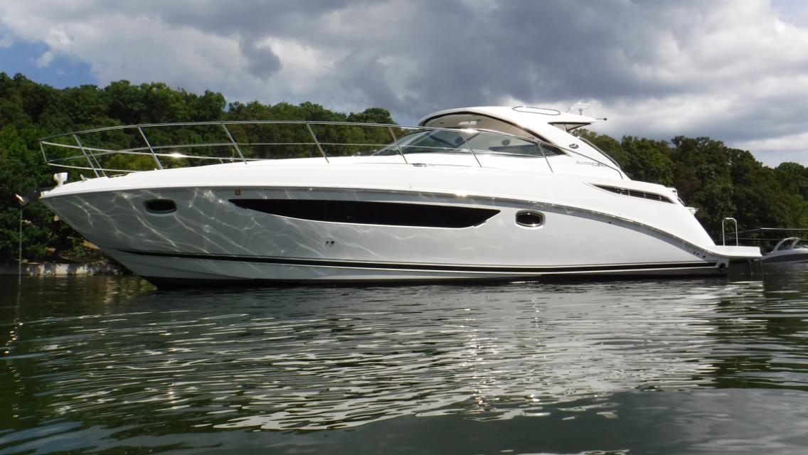 Sea Ray 410 Sundancer 2014 Sea Ray 410 Sundancer yacht on calm water, surrounded by lush greenery.
