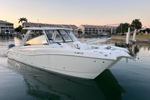 World Cat 325 DC 2022 World Cat 325 DC boat docked in a serene marina at sunset.