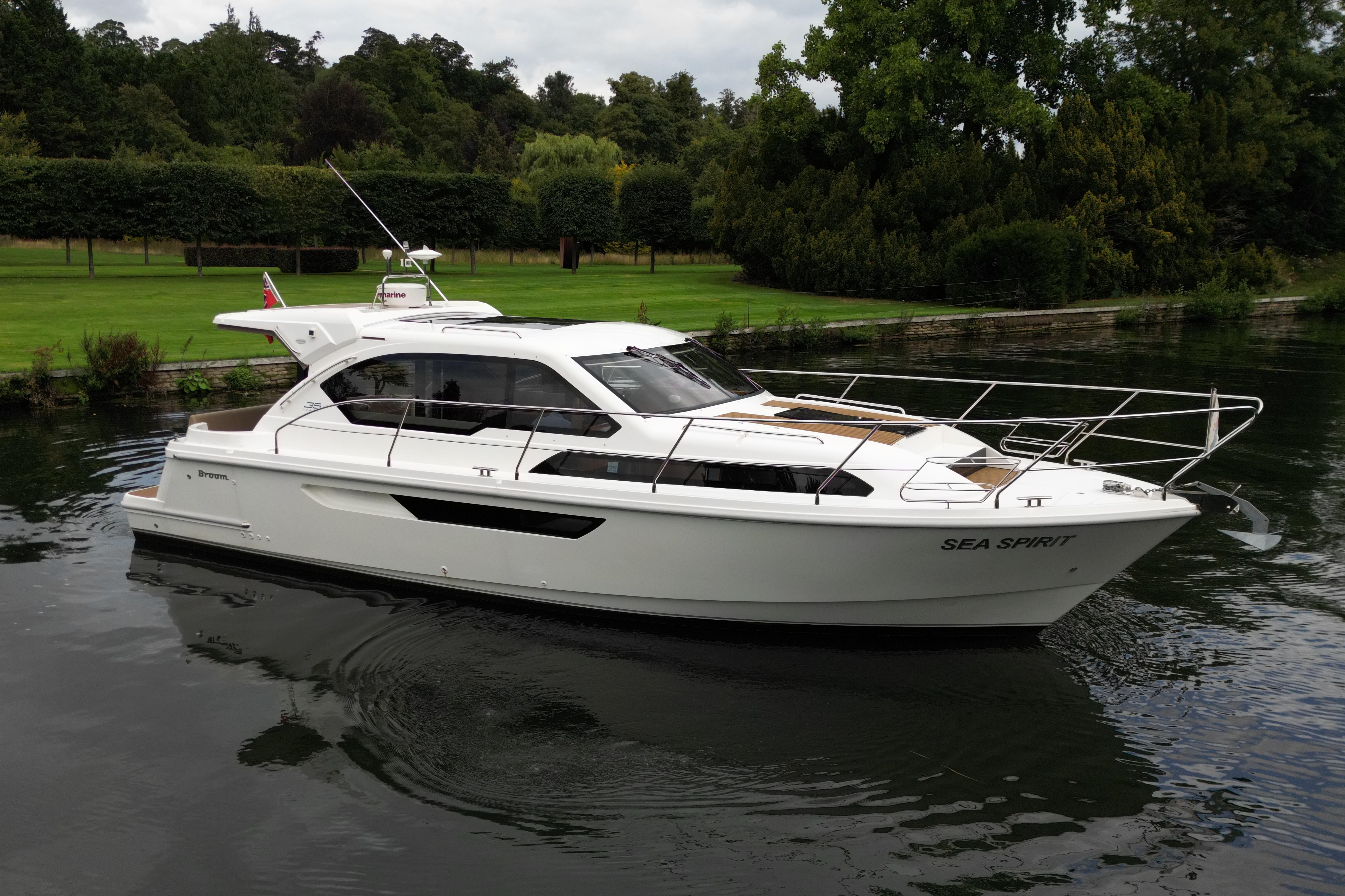 Broom 35 Coupe 2015 Broom 35 Coupe boat on a serene river, surrounded by lush greenery.